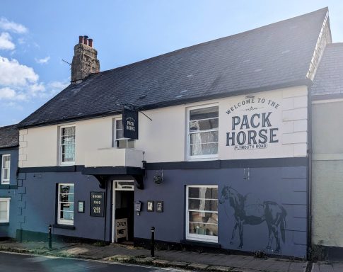 Exterior of the Pack Horse pub with a horse mural on the wall.