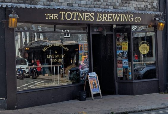 Front view of the Totnes Brewing Co. with outdoor seating and a welcoming entrance.