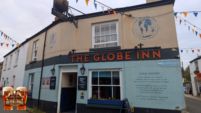 Exterior of The Globe Inn pub with colourful bunting and decorative signage.